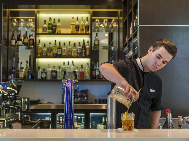 The Point Brisbane Hotel Exteriör bild A bartender at work